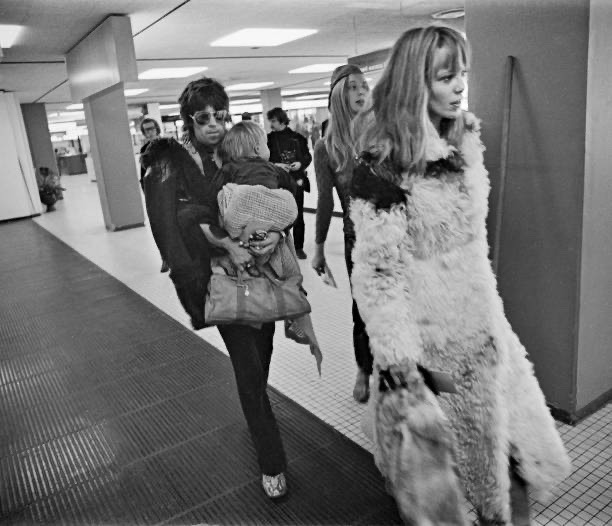 Anita Pallenberg with Keith Richards of The Rolling Stones holding their son Marlon at Schiphol Airport, Netherlands, returning home after the last date of The Rolling Stones European Tour, 10th October 1970. (Photo by Gijsbert Hanekroot/Redferns)